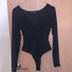 Black long sleeve body suit/one piece. Knot detailing